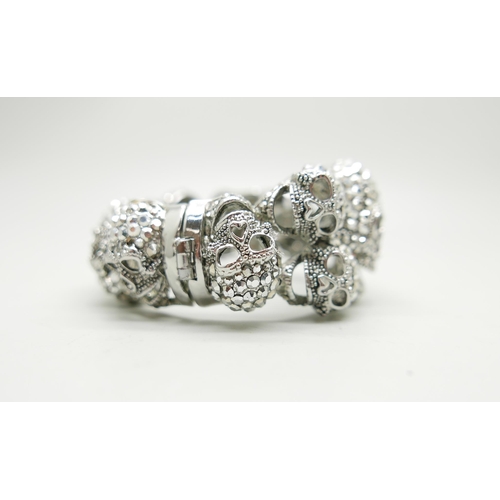 836 - A Butler & Wilson large skull bracelet, some stones missing, 6cm x 5cm