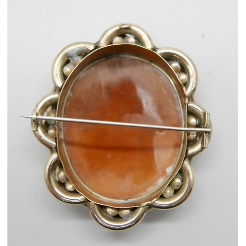 890 - A large pinchbeck carved cameo brooch in an antique fitted case, 6.5cm x 5.5cm