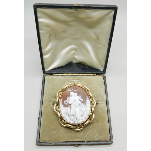 890 - A large pinchbeck carved cameo brooch in an antique fitted case, 6.5cm x 5.5cm
