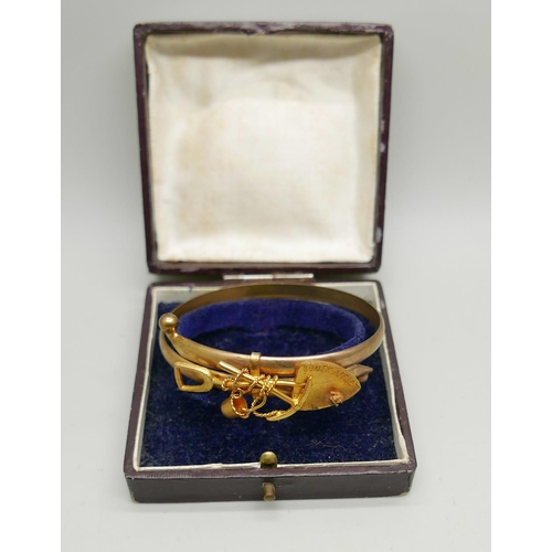 900 - A Victorian unmarked rolled gold South Africa mining bangle, in a fitted case