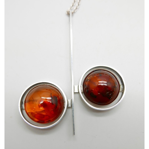 905 - A .830 silver Modernist style amber pendant, a silver and amber bracelet and another amber bracelet