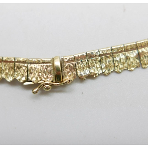 906 - A 9ct gold fringe necklace with textured design, 44.5cm, 22g