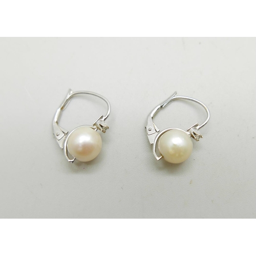 991 - A pair of UnoAerre 18ct white gold earrings set with pearls and white stones, 2.6g