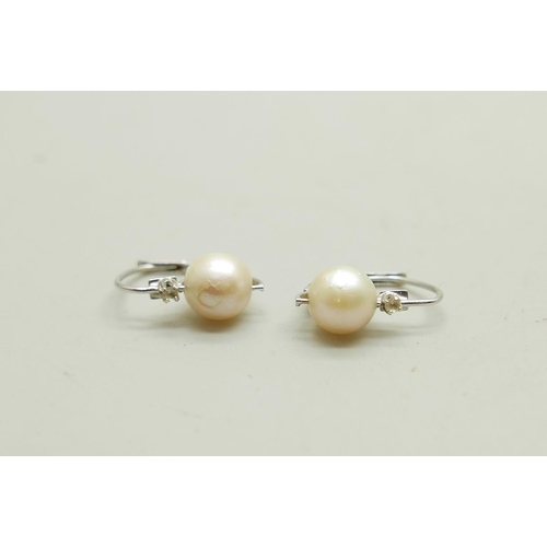 991 - A pair of UnoAerre 18ct white gold earrings set with pearls and white stones, 2.6g