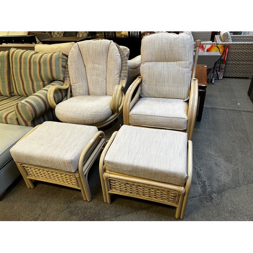 1550 - Cane swivel armchair and a standard armchair, each with footstool