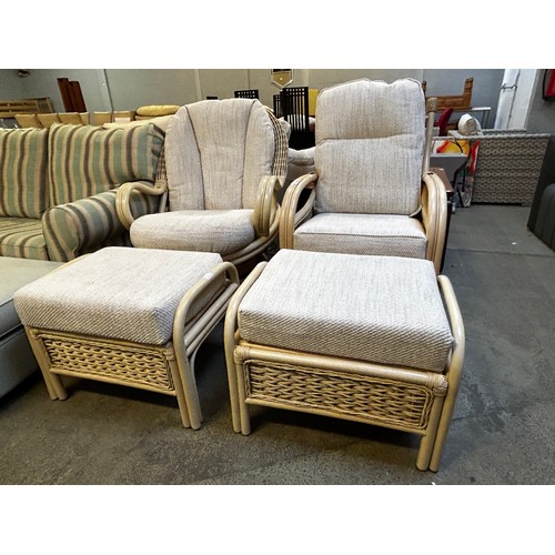 1550 - Cane swivel armchair and a standard armchair, each with footstool