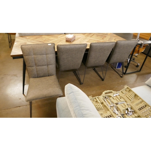 1307 - A set of four grey leather effect dining chairs *This lot is subject to VAT