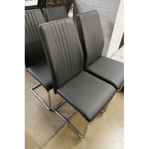 1367 - A set of four black & chrome dining chairs *This lot is subject to VAT