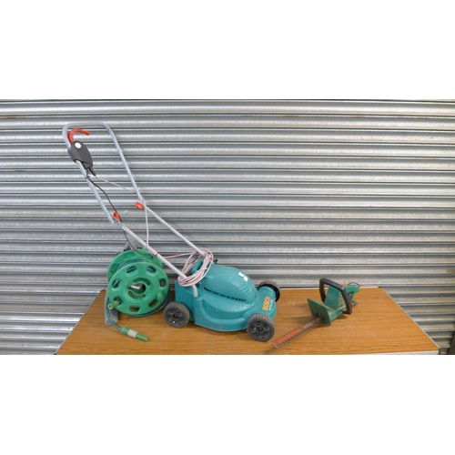 2232 - A BOSCH Rotak 320c electric lawn mower, a Qualcast HC35 electric hedge cutter and a hose pipe and re... 