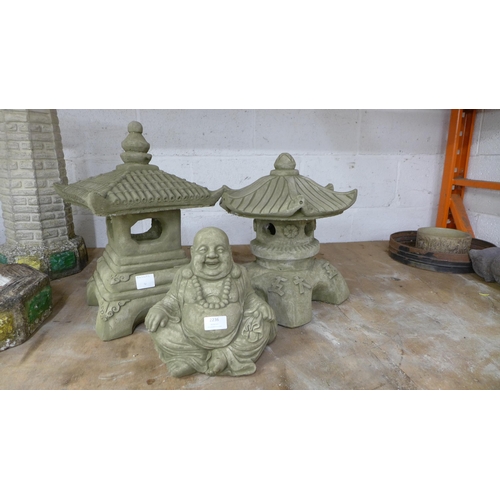 2236 - Two stone effect concrete Pagoda's and a stone effect concrete sitting Buddha figure