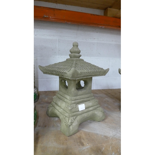 2236 - Two stone effect concrete Pagoda's and a stone effect concrete sitting Buddha figure