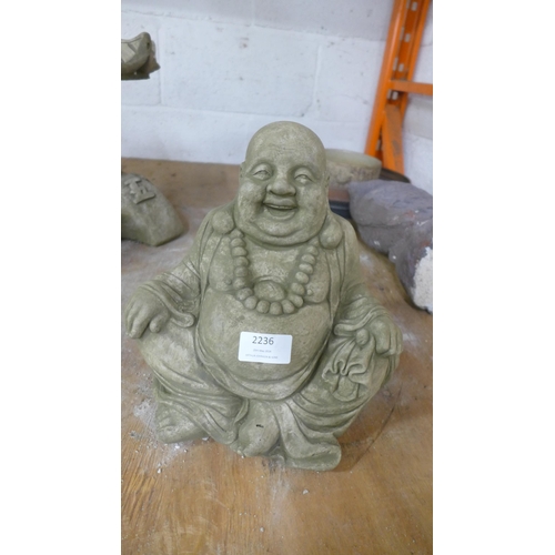 2236 - Two stone effect concrete Pagoda's and a stone effect concrete sitting Buddha figure