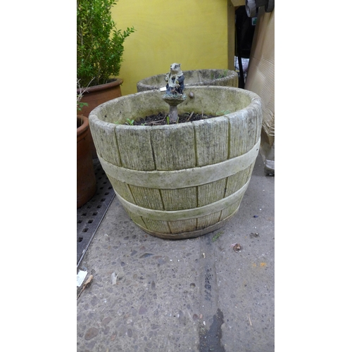 2258 - A pair of stone effect concrete whiskey barrel style planters