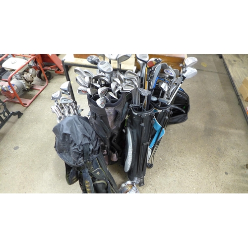 2282 - Five golf bags containing a large quantity of assorted golf clubs including Donnay, MCX, MacGregor, ... 