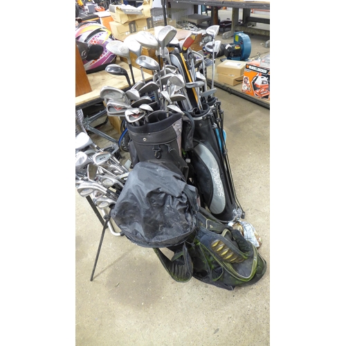 2282 - Five golf bags containing a large quantity of assorted golf clubs including Donnay, MCX, MacGregor, ... 