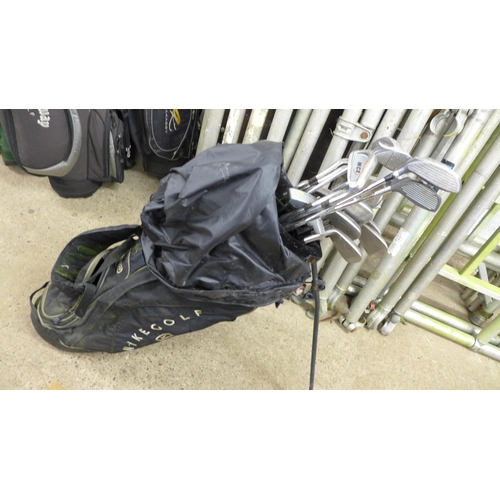 2282 - Five golf bags containing a large quantity of assorted golf clubs including Donnay, MCX, MacGregor, ... 