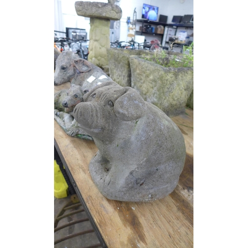 2301 - A concrete pig garden ornament and a concrete cow and calf ornament