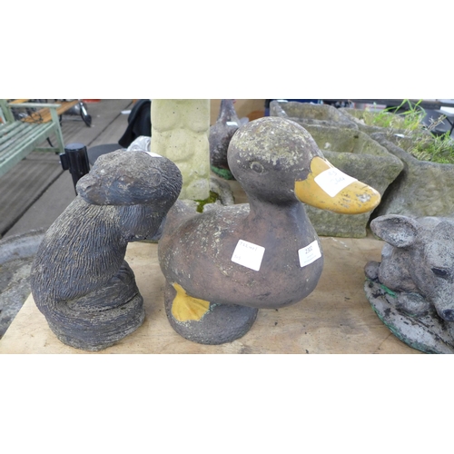 2302 - A concrete duck garden ornament and a concrete otter garden ornament