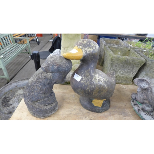 2302 - A concrete duck garden ornament and a concrete otter garden ornament