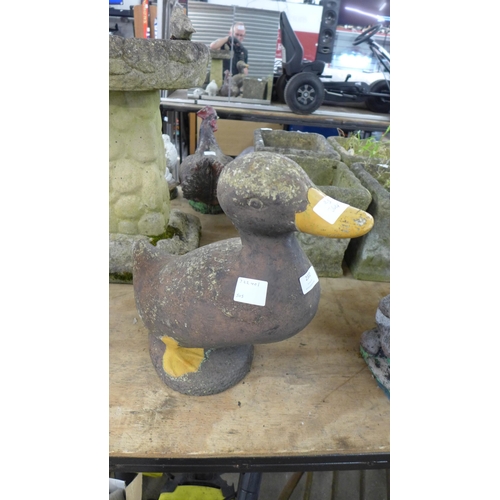 2302 - A concrete duck garden ornament and a concrete otter garden ornament