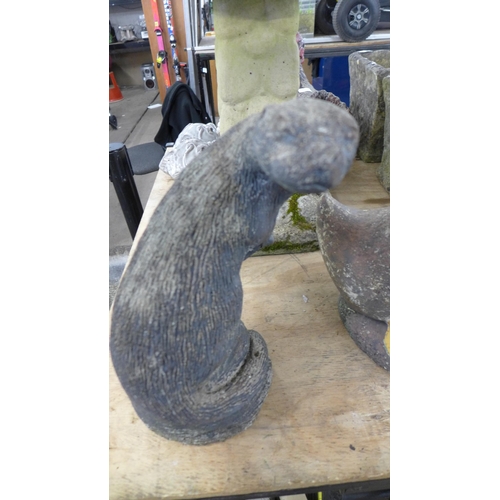 2302 - A concrete duck garden ornament and a concrete otter garden ornament