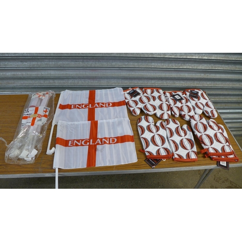 2345 - A large quantity of patterned kitchen/oven gloves and 30 x 46cm St. George Cross car flags