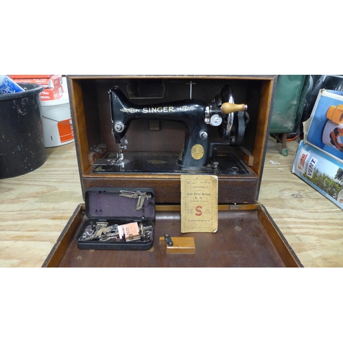 2377 - A vintage Singer EC182136 sewing machine with hard case, instructions and a box of sewing machine ac... 