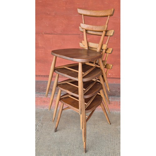 56 - A set of four Ercol Blonde elm and beech green dot stacking chairs