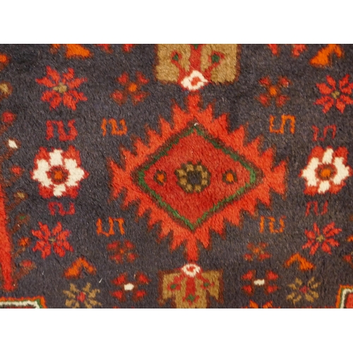 1501 - A Rich Red ground handwoven full wool pile Persian village rug (195x130cm)