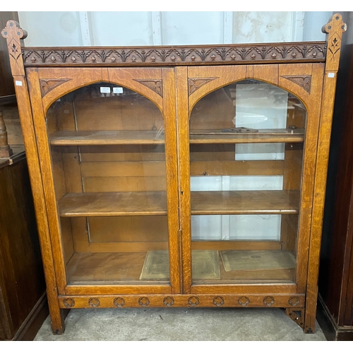 94 - A Victorian Aesthetic Movement oak two door bookcase