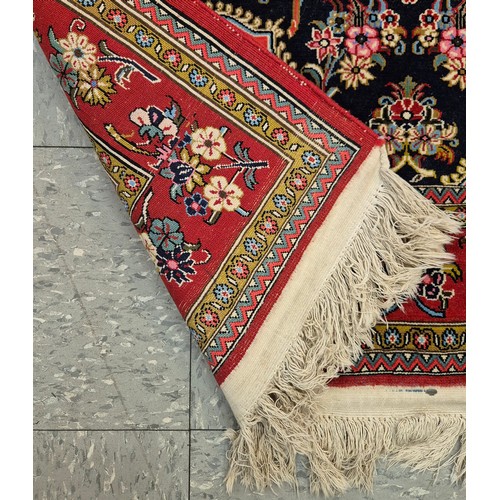 90C - A Persian red ground floral pattern rug