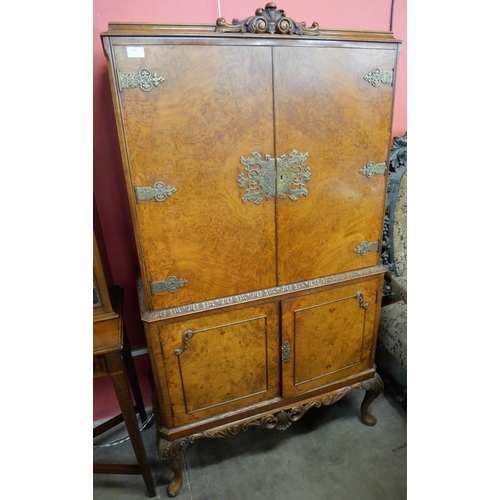 109 - A Queen Anne style figured walnut cocktail cabinet