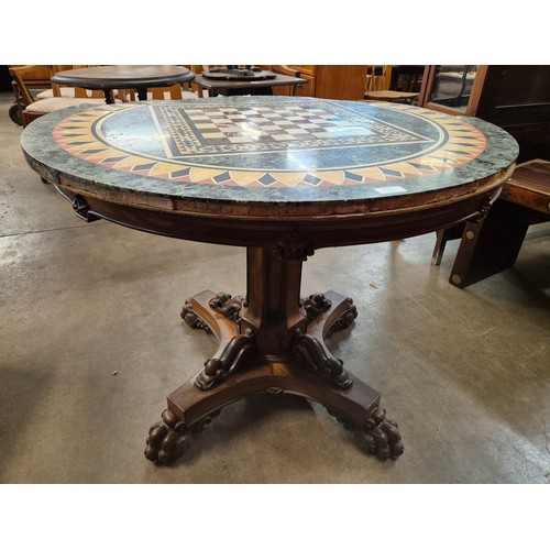 96 - A Regency mahogany and specimen marble topped circular centre/games table