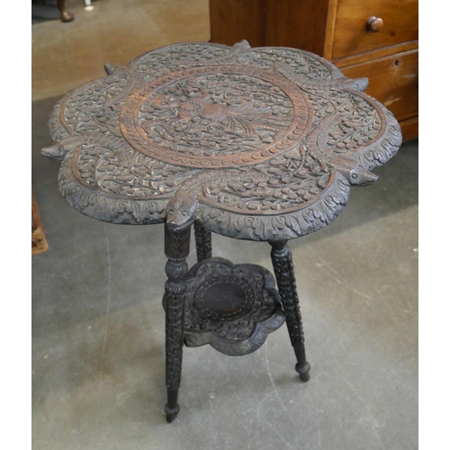 114A - A Burmese carved hardwood occasional table