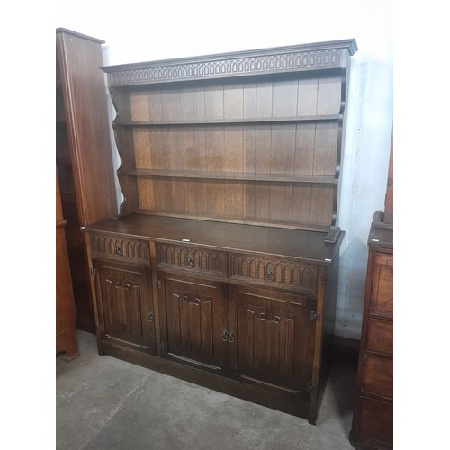 123 - A carved oak linenfold dresser