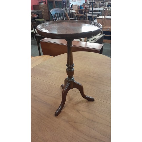 127 - A mahogany tripod wine table