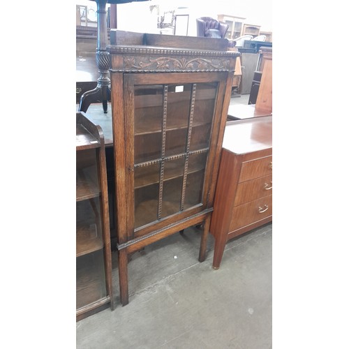 133 - An early 20th Century carved oak corner cabinet