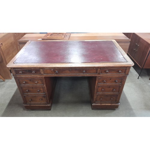 134 - A Victorian oak pedestal library desk