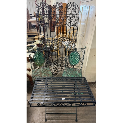 271 - A painted wrought iron garden table, two chairs and a screen