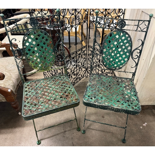 271 - A painted wrought iron garden table, two chairs and a screen