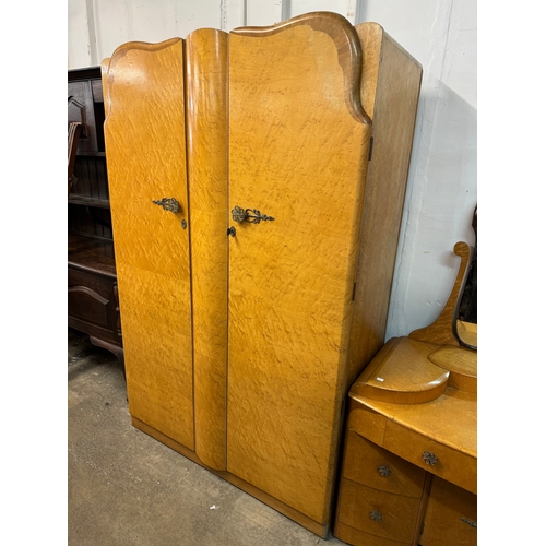 249 - An Art Deco birds eye maple bedroom suite, comprising; two wardrobes, a pair of bedside chests and a... 