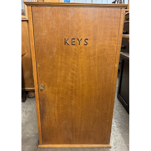 414 - A beech two door key cupboard