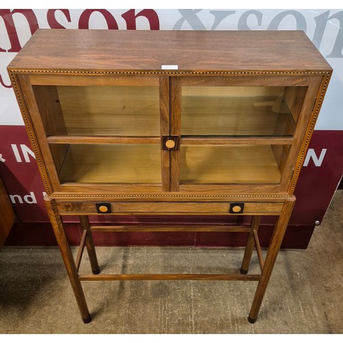 1 - An Art Deco style inlaid walnut two door side cabinet on stand