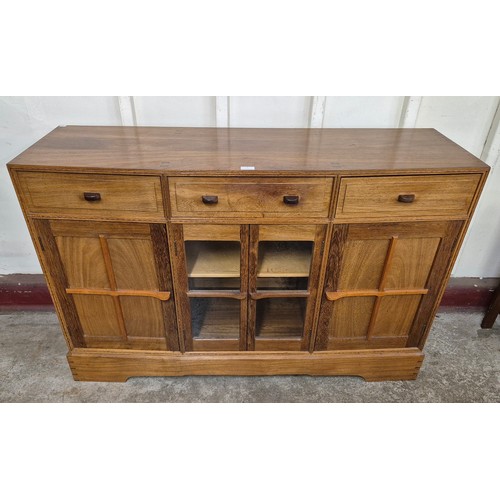 4 - An Art Deco style walnut six piece dining suite, comprising; sideboard, table and four chairs