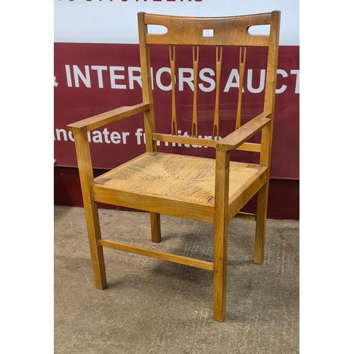 10 - A Danish style walnut and rush seated elbow chair
