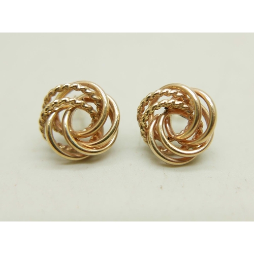 1011 - A pair of 10k gold knot design stud earrings, 1.6g