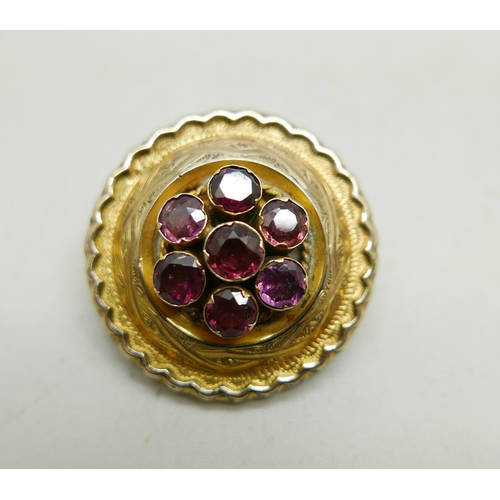 1014 - A Victorian yellow metal mourning brooch set with seven amethysts, 11g, 3.1cm