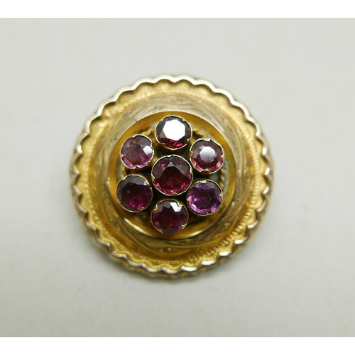 1014 - A Victorian yellow metal mourning brooch set with seven amethysts, 11g, 3.1cm