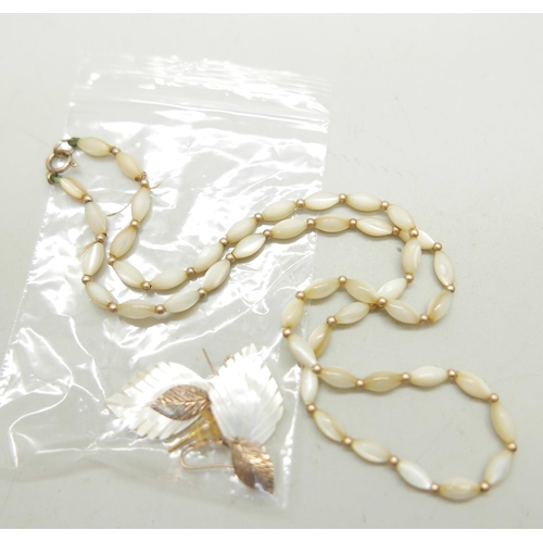 1022 - A 9ct gold bead and mother of pearl necklace, the clasp marked 9ct, and two pairs of earrings