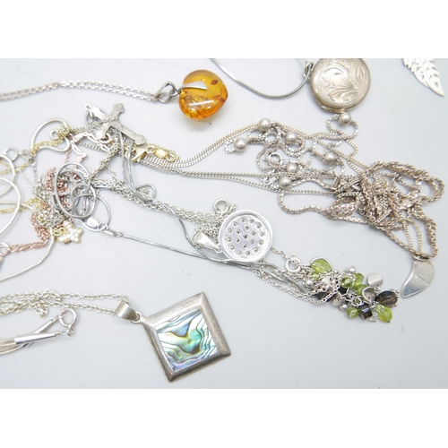 1026 - A collection of silver pendants and chains, 82g